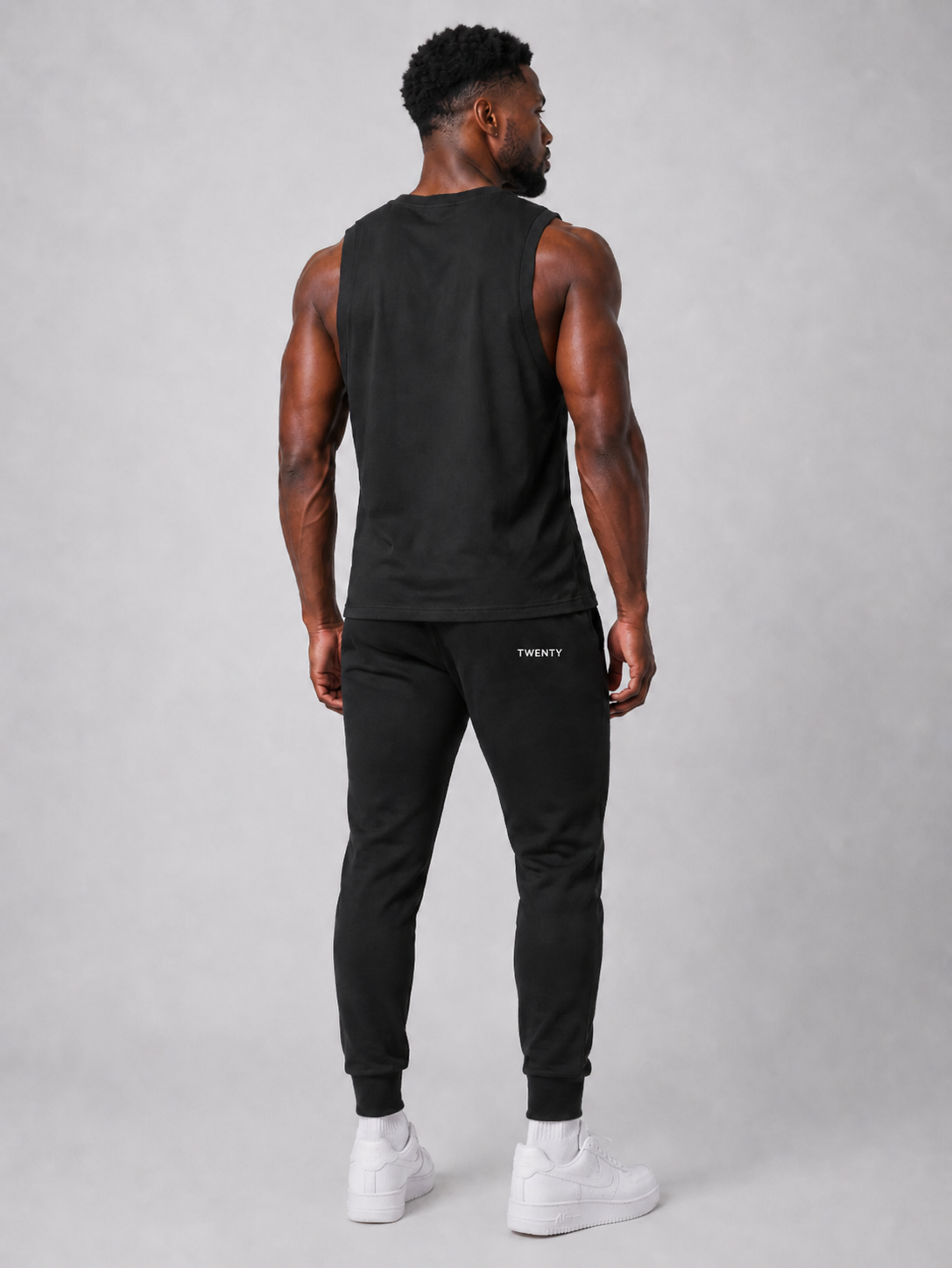 TWENTY Performance Vest in midnight black, sleek athletic vest from TWENTY Fitness, displayed flat on a white background.