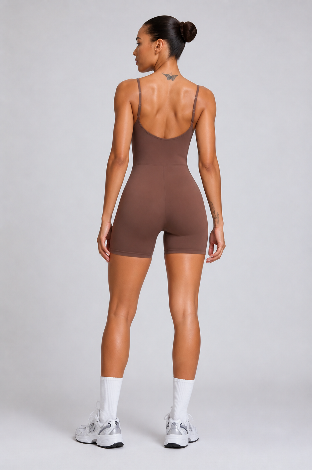 TWENTY Fitness Cocoa Sculpt Unitard showing a fitted, seamless activewear one-piece with a high neckline and sleek design.