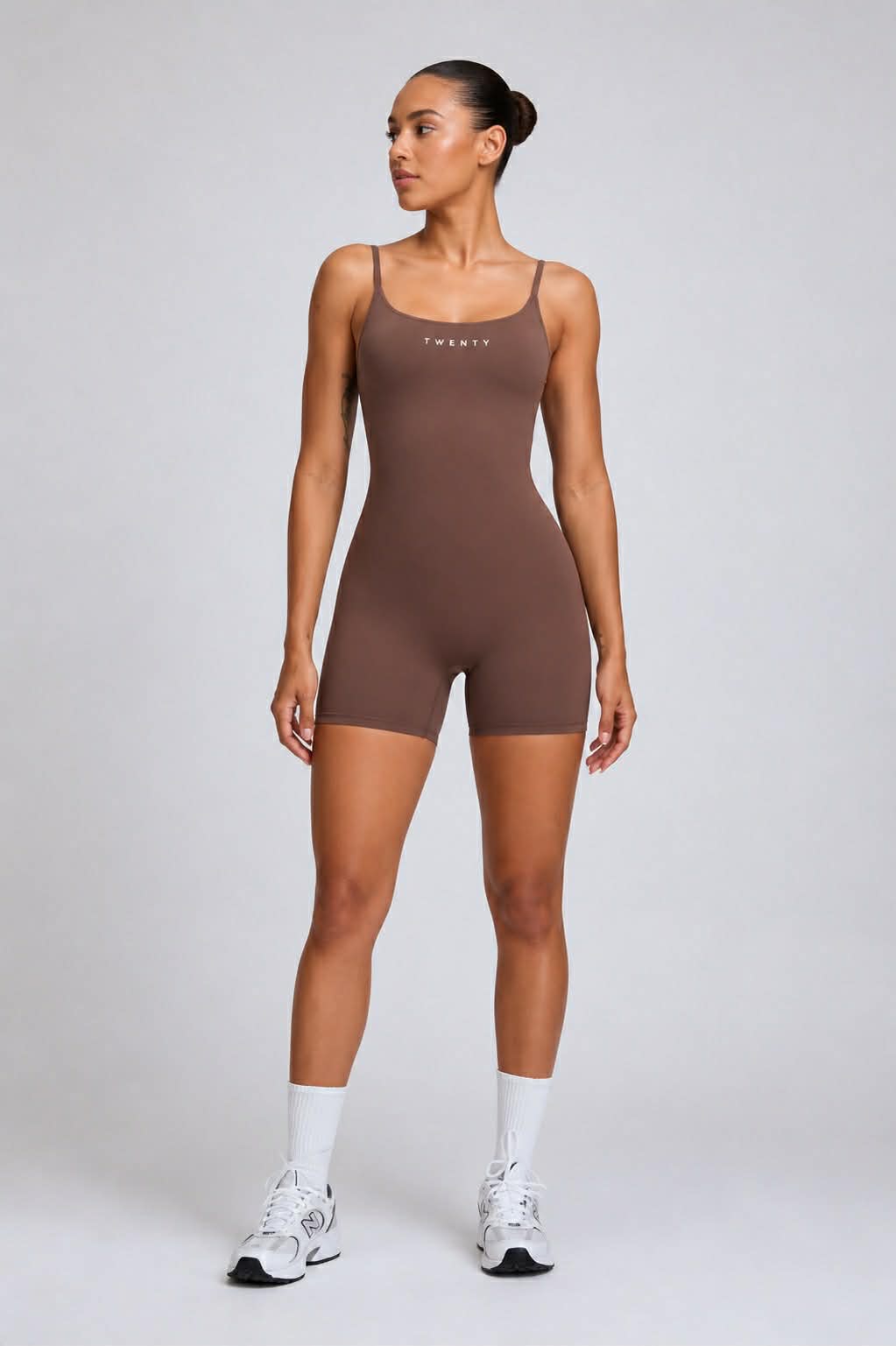 TWENTY Fitness Sculpt Unitard in Cocoa, form-fitting activewear with a sleek design, shown on a model.